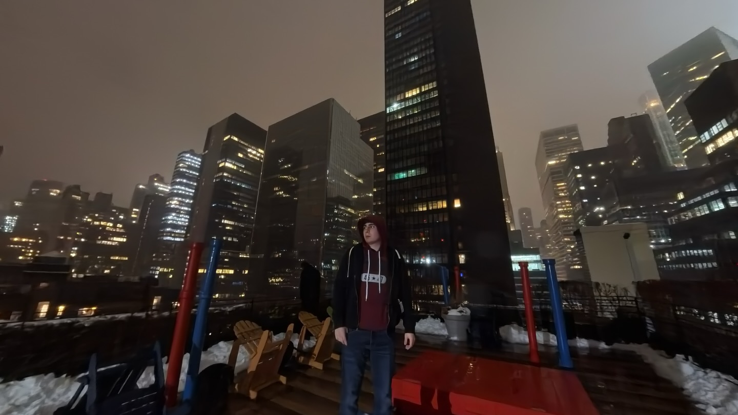 Saucy Justin on a New York City rooftop at night